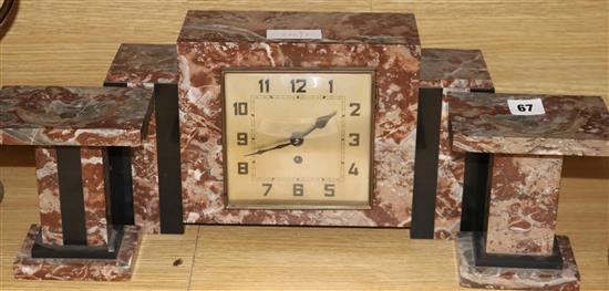 An Art Deco rouge marble clock garniture